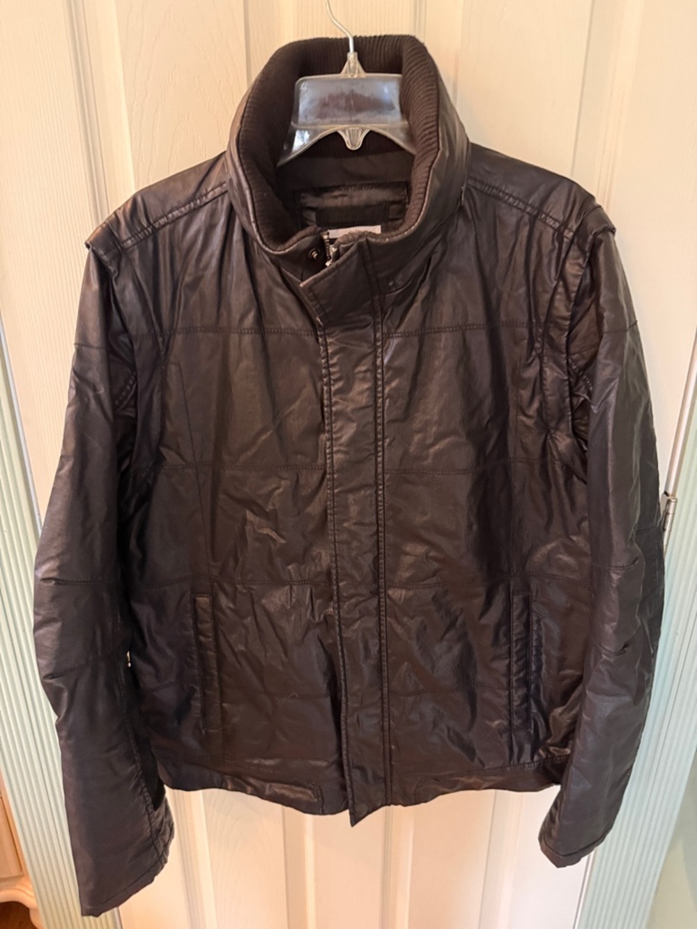 Calvin Klein Faux Leather Jacket w/hidden hood and removable zippered sleeves.